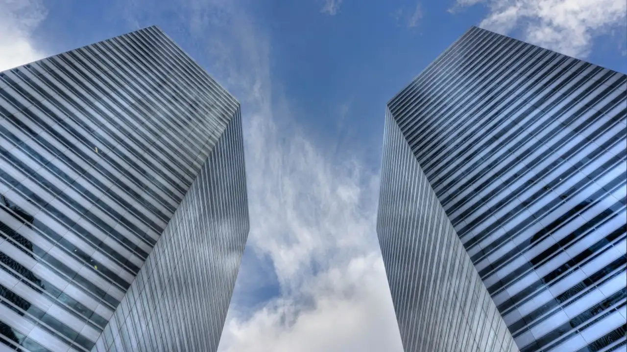 Close up on a plate of mashed potatoes, topped with baked pork chops with cream of mushroom soup, and a side of green beans.