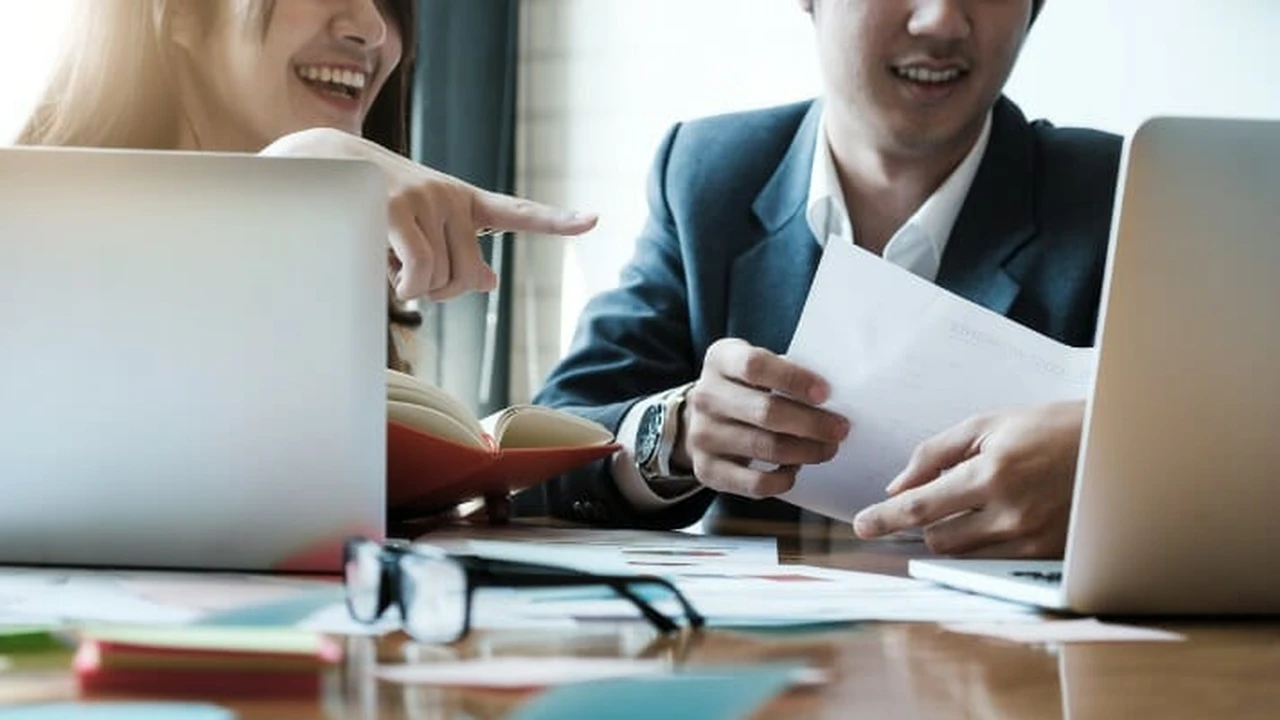 Close up on a plate of mashed potatoes, topped with baked pork chops with cream of mushroom soup, and a side of green beans.