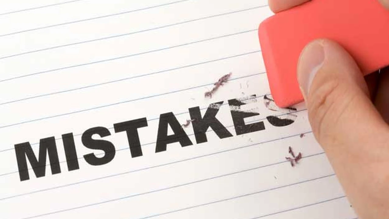 Close up on a plate of mashed potatoes, topped with baked pork chops with cream of mushroom soup, and a side of green beans.